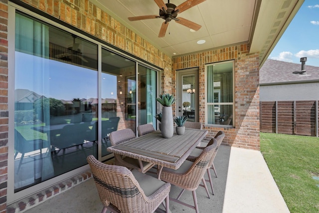 view of patio / terrace with ceiling fan, fence, and outdoor dining space