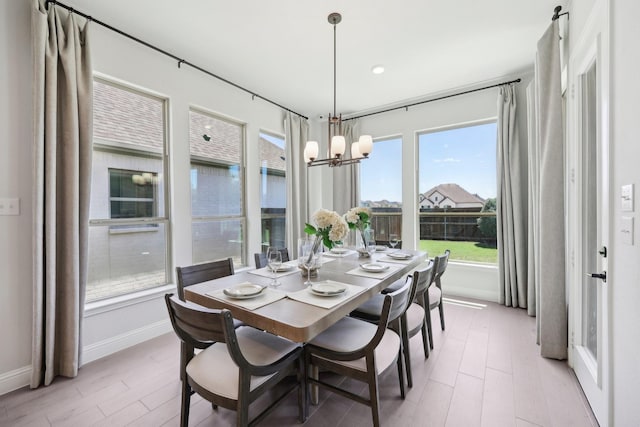 dining space featuring recessed lighting, baseboards, a notable chandelier, and light wood finished floors