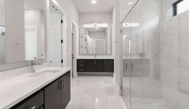 bathroom featuring two vanities, a sink, tile patterned flooring, and a stall shower