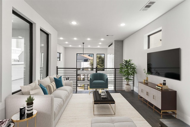 living area with visible vents, recessed lighting, dark wood finished floors, and baseboards