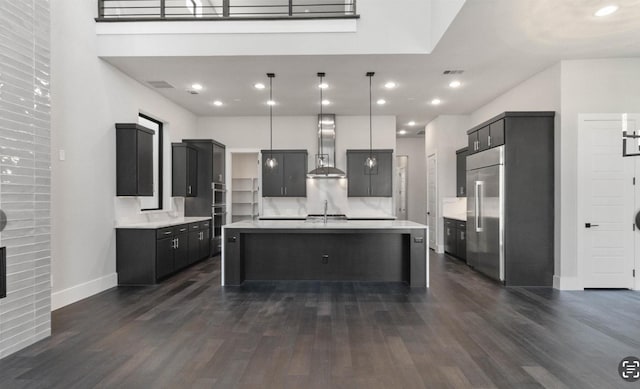 7840 Secluded Ave, Plano, TX 75024 - kitchen featuring wall chimney range hood, stainless steel built in fridge, a sink, light countertops, and dark wood finished floors
