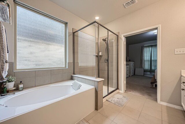 7520 Gangway Dr, Fort Worth, TX 76179 - bathroom featuring tile patterned flooring, vanity, visible vents, a bath, and a stall shower