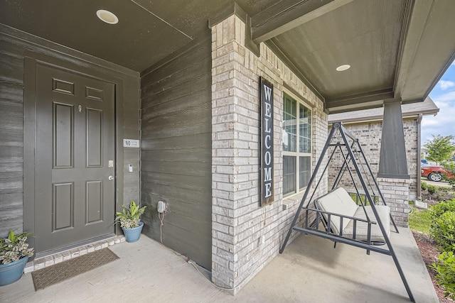 7520 Gangway Dr, Fort Worth, TX 76179 - doorway to property featuring a porch and brick siding