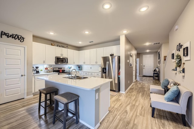 7520 Gangway Dr, Fort Worth, TX 76179 - kitchen with a sink, light wood-style floors, light countertops, stainless steel appliances, and visible vents