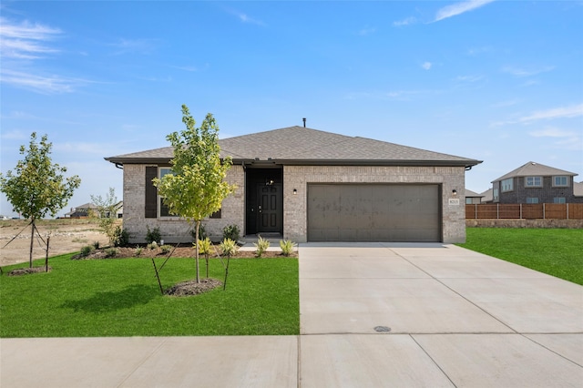 single story home with fence, a front lawn, brick siding, a garage, and concrete driveway
