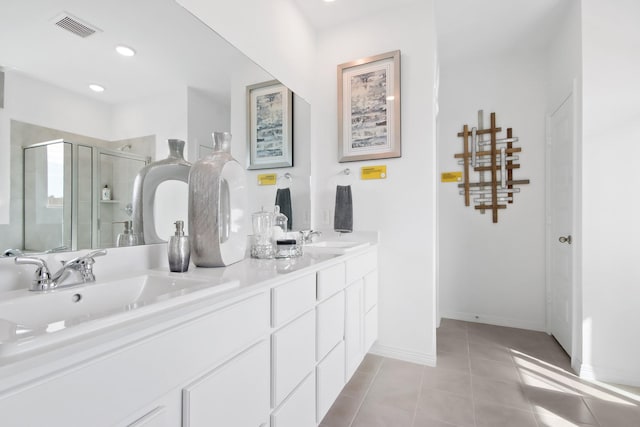 full bathroom with a sink, tile patterned flooring, double vanity, visible vents, and a stall shower