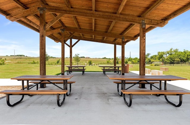 view of home's community featuring a lawn, a patio area, and outdoor dining space