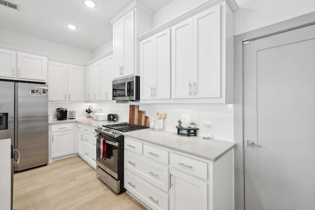 8613 Keeneland Dr, Fort Worth, TX 76120 - kitchen with white cabinets, stainless steel appliances, and visible vents