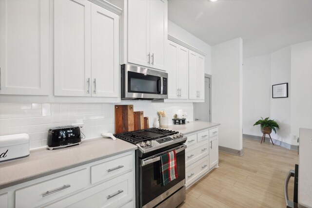8613 Keeneland Dr, Fort Worth, TX 76120 - kitchen with light countertops, stainless steel appliances, white cabinetry, and tasteful backsplash