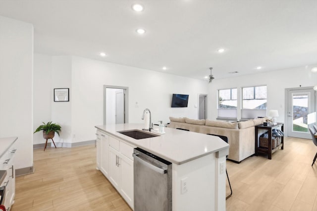 8613 Keeneland Dr, Fort Worth, TX 76120 - kitchen featuring stainless steel dishwasher, recessed lighting, white cabinets, a sink, and light wood finished floors
