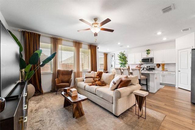 859 Sitwell Dr, Fate, TX 75087 - living room featuring recessed lighting, ceiling fan, visible vents, and light wood-style floors