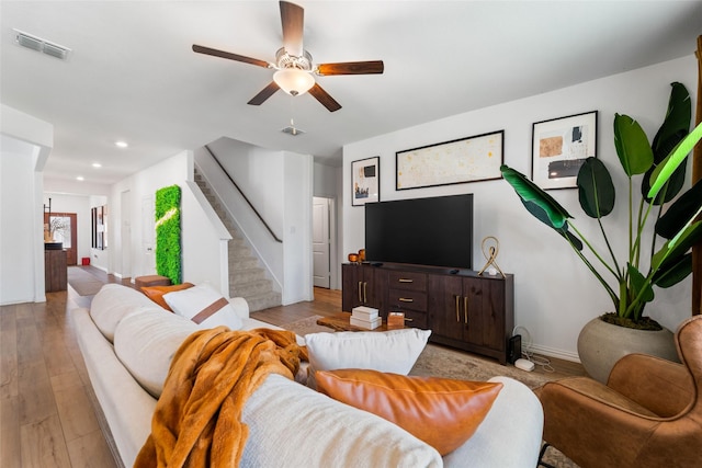 859 Sitwell Dr, Fate, TX 75087 - living room featuring a ceiling fan, visible vents, light wood-type flooring, stairway, and baseboards