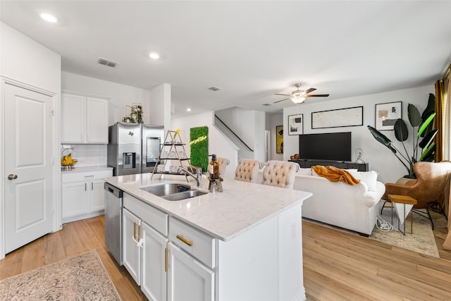 859 Sitwell Dr, Fate, TX 75087 - kitchen with ceiling fan, light wood-type flooring, white cabinetry, a sink, and stainless steel appliances
