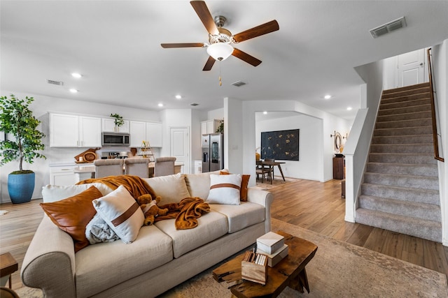 859 Sitwell Dr, Fate, TX 75087 - living area featuring a ceiling fan, visible vents, and stairway
