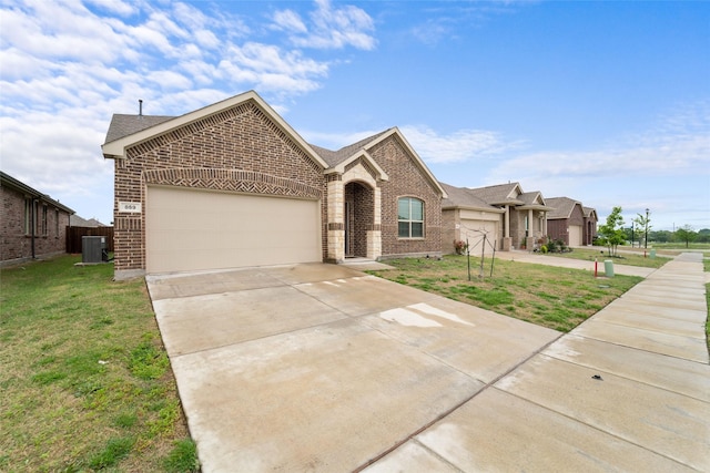 859 Sitwell Dr, Fate, TX 75087 - view of front of property with a garage, concrete driveway, a front lawn, and brick siding