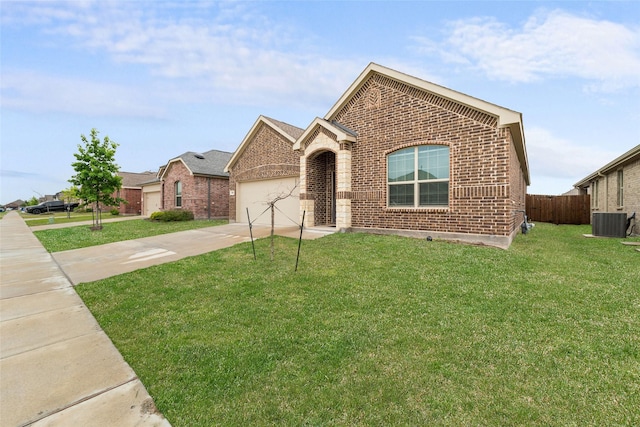 859 Sitwell Dr, Fate, TX 75087 - single story home with driveway, a front yard, central AC unit, brick siding, and an attached garage