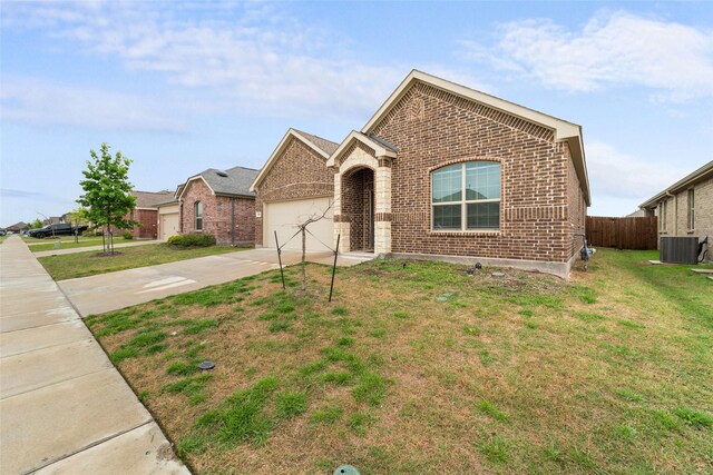 859 Sitwell Dr, Fate, TX 75087 - ranch-style home with fence, brick siding, central AC unit, an attached garage, and driveway