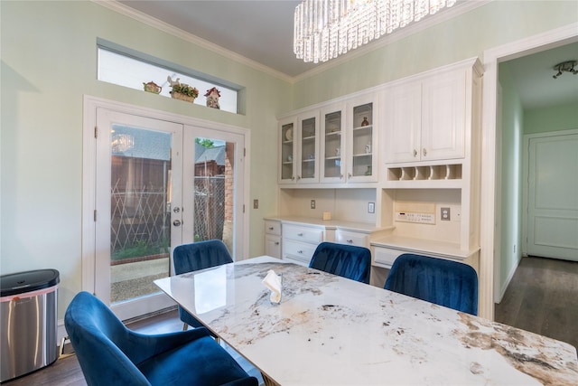 dining room with crown molding, french doors, and dark wood finished floors