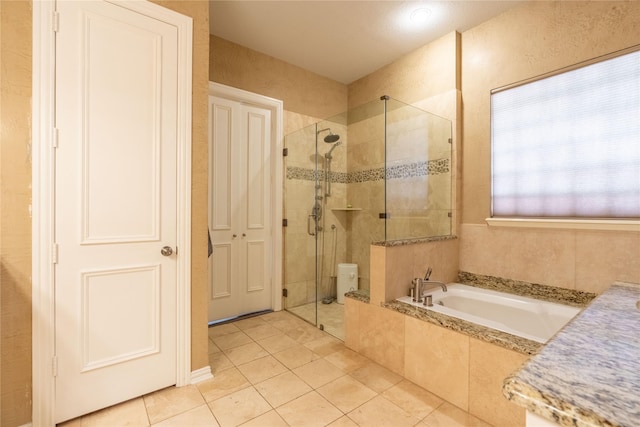 bathroom with tile patterned flooring, a bath, and a stall shower