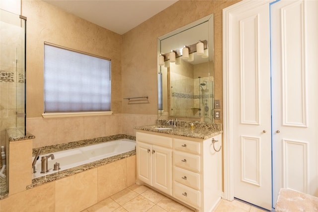 full bath featuring vanity, tile patterned flooring, a tile shower, and a bath