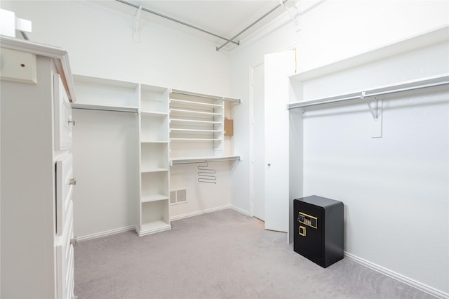 spacious closet with light carpet and visible vents