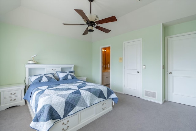 bedroom featuring ceiling fan, ensuite bath, carpet floors, baseboards, and visible vents