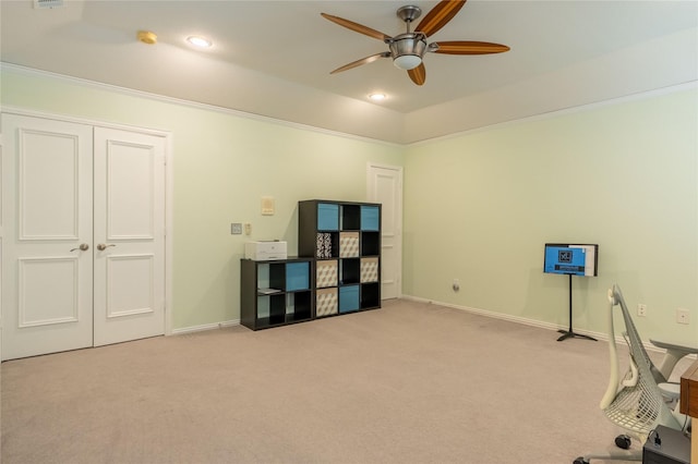 office space featuring light colored carpet, a ceiling fan, baseboards, and recessed lighting
