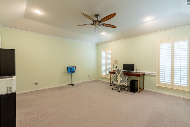 home office featuring a raised ceiling, plenty of natural light, a ceiling fan, and carpet flooring