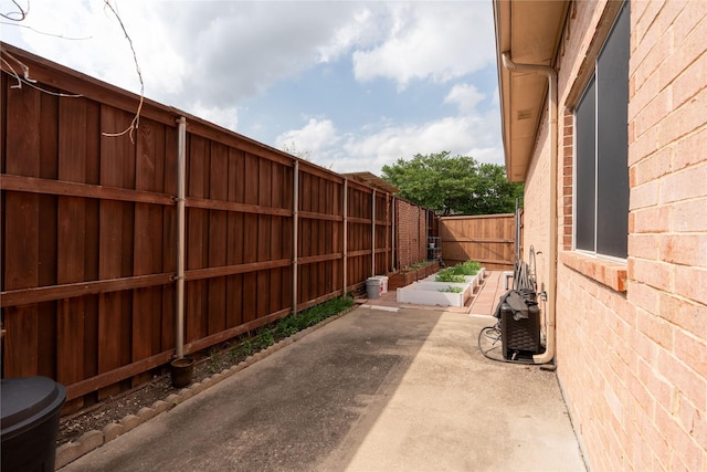 view of patio / terrace featuring a fenced backyard and a vegetable garden