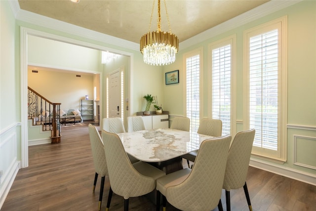 dining space featuring wainscoting, stairway, dark wood-style floors, a chandelier, and ornamental molding