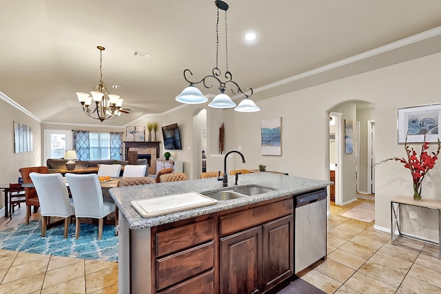 733 Ravenwood Dr, Saginaw, TX 76179 - kitchen featuring stainless steel dishwasher, a sink, arched walkways, light tile patterned floors, and ornamental molding