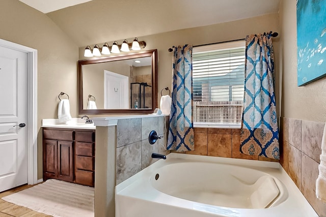 733 Ravenwood Dr, Saginaw, TX 76179 - bathroom featuring a bath, vanity, and lofted ceiling