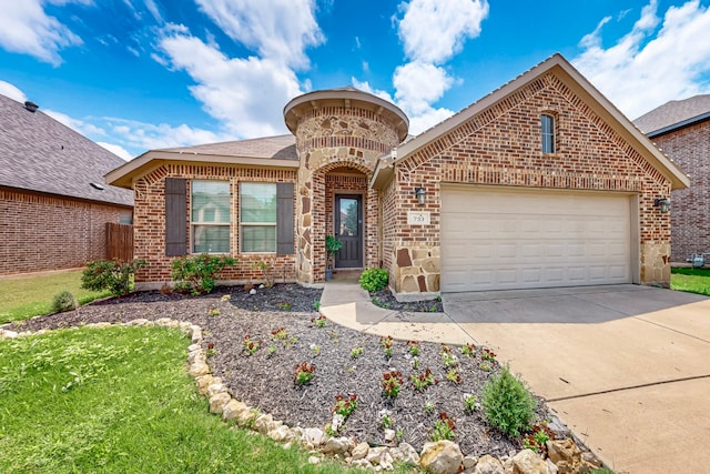 733 Ravenwood Dr, Saginaw, TX 76179 - french country style house featuring brick siding, an attached garage, driveway, and a shingled roof