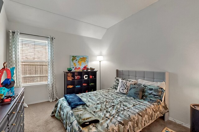733 Ravenwood Dr, Saginaw, TX 76179 - carpeted bedroom featuring multiple windows, vaulted ceiling, and baseboards