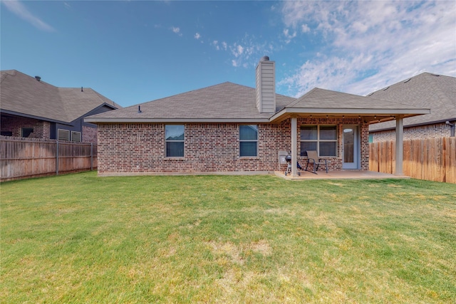 733 Ravenwood Dr, Saginaw, TX 76179 - back of house with brick siding, a patio area, and a chimney