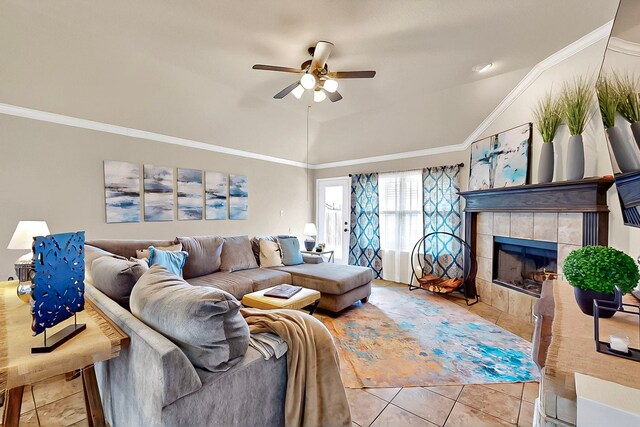733 Ravenwood Dr, Saginaw, TX 76179 - living room featuring light tile patterned floors, ceiling fan, lofted ceiling, ornamental molding, and a tile fireplace