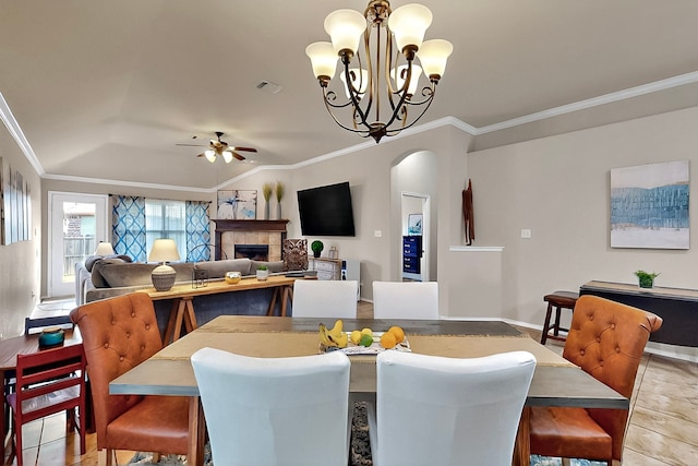 733 Ravenwood Dr, Saginaw, TX 76179 - dining area with crown molding, arched walkways, a ceiling fan, a fireplace, and a chandelier