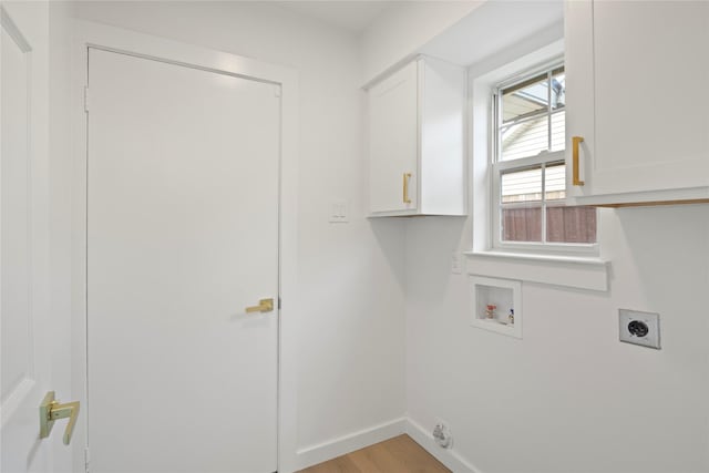 laundry room with washer hookup, hookup for an electric dryer, cabinet space, baseboards, and light wood-style floors