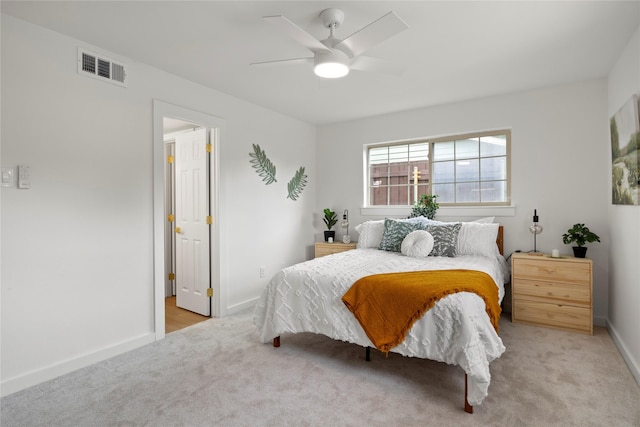 bedroom with visible vents, baseboards, carpet floors, and ceiling fan