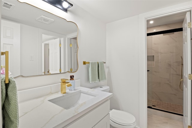 full bath with vanity, toilet, visible vents, and a stall shower