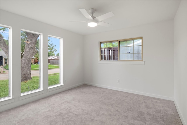 unfurnished room featuring baseboards, ceiling fan, and carpet flooring