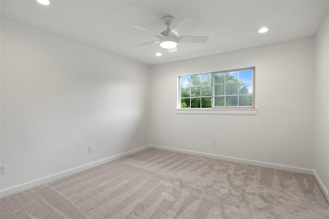 carpeted spare room featuring recessed lighting, baseboards, and a ceiling fan