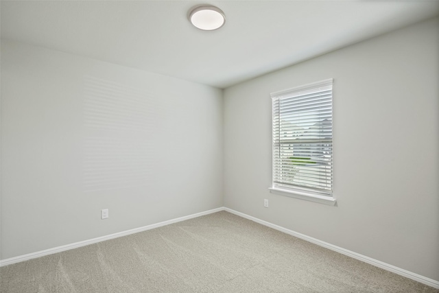 carpeted empty room with baseboards