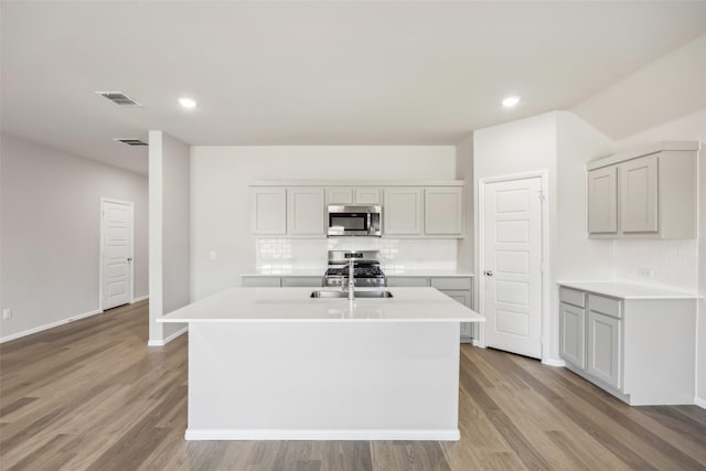 kitchen featuring light countertops, tasteful backsplash, and stainless steel appliances