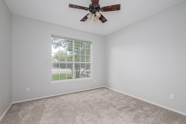 unfurnished room with baseboards, carpet flooring, and ceiling fan