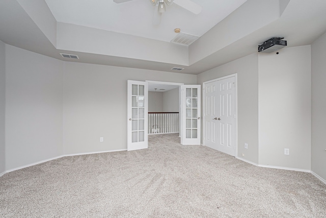 unfurnished bedroom with baseboards, visible vents, french doors, and carpet