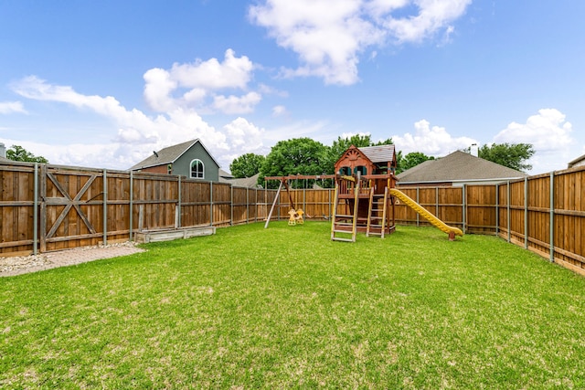 view of yard with a fenced backyard and a playground