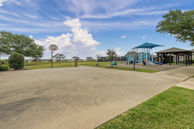 exterior space featuring a lawn, community basketball court, playground community, and a gazebo