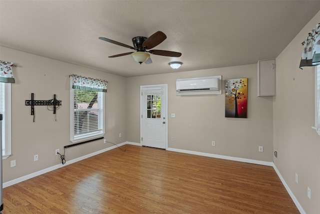 2311 Cedar Cir, Granbury, TX 76048 - foyer with an AC wall unit, ceiling fan, light wood-type flooring, and baseboards