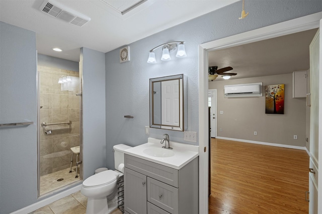 2311 Cedar Cir, Granbury, TX 76048 - full bath with a wall mounted air conditioner, toilet, a shower stall, a ceiling fan, and vanity